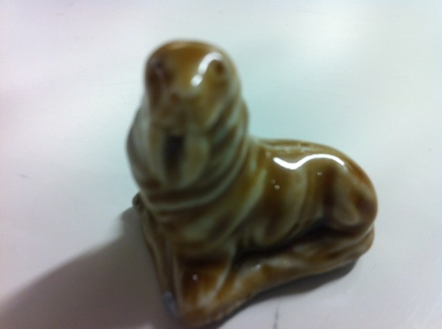 Badly taken photo of small green ceramic walrus